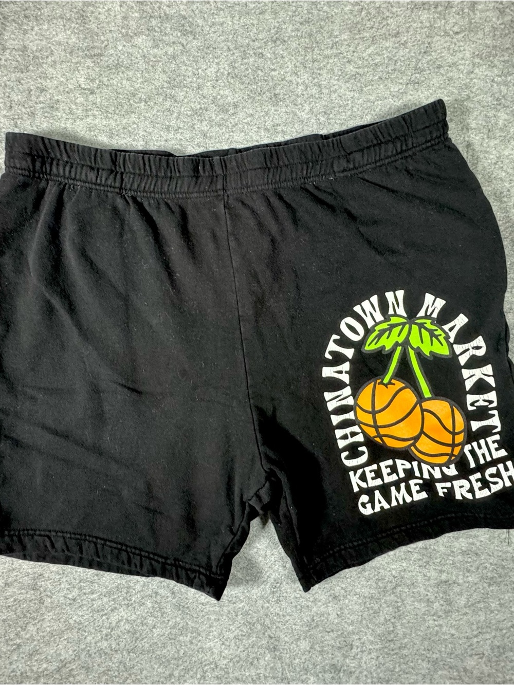 Chinatown Market Black Athletic Shorts with Orange Cherry-Basketball Graphic